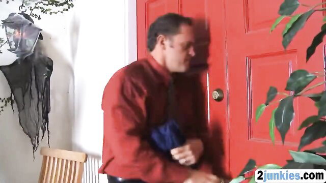 Man in red shirt with bag at door in horny babysitter scene