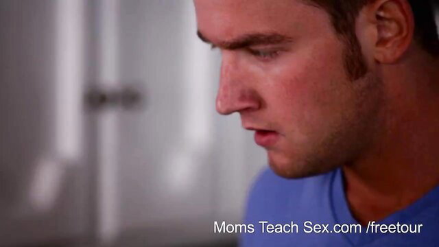 Handsome young man in blue tee stares intently, Moms Teach Sex thumbnail