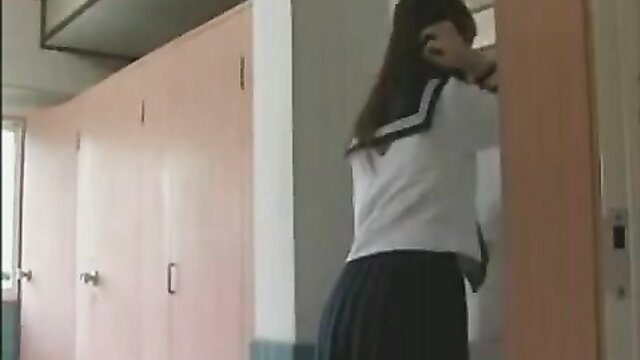 Hot Japanese schoolgirl in sailor uniform peeking from bathroom door