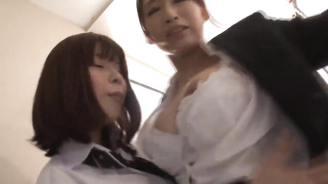 Two busty Asian women in schoolgirl and office attire, deep cleavage tease