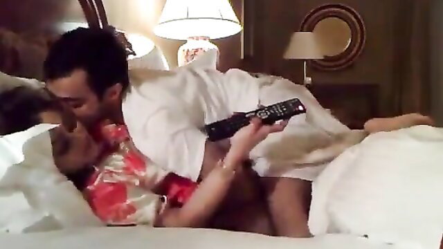 Tamil couple kissing intimately on bed in silk robes