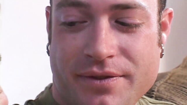 Closeup of hot guy with goatee smirking in threesome preview