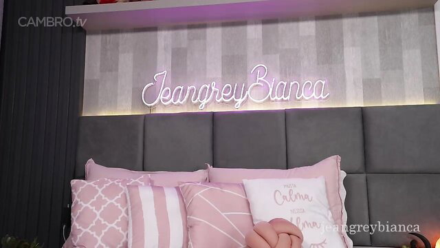 Jeangreybianca in pink lingerie on bed, teasing solo cam show