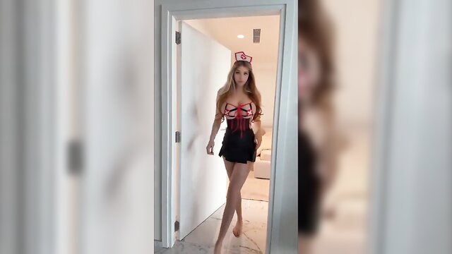 Blonde bombshell in sexy nurse costume struts seductively