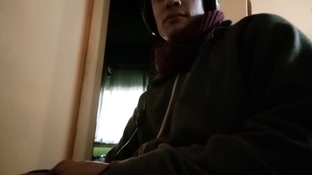 Latino guy at home in hoodie and scarf, amateur spycam closeup