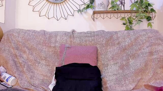 Emmaduque ebony camgirl teases on couch with pink pillow and black skirt
