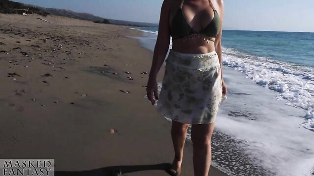 Hot mature babe in skimpy green bikini and skirt on beach