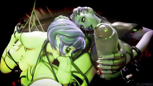 Two sexy green alien babes in latex bondage sucking glowing cock