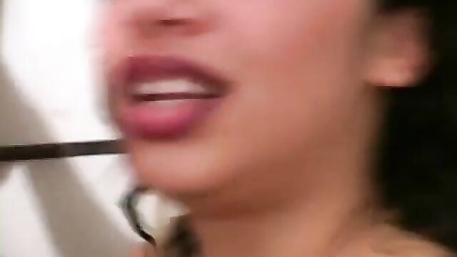 Alexis Silver's plump lips teasing black dildo closeup