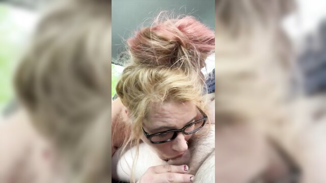 Blonde streetwalker with glasses in messy pinkish bun, closeup face view