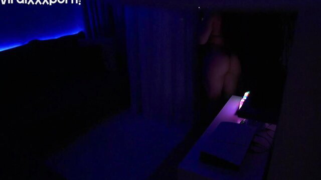 Hot girl bends over in dim blue-lit room showing ass and curves