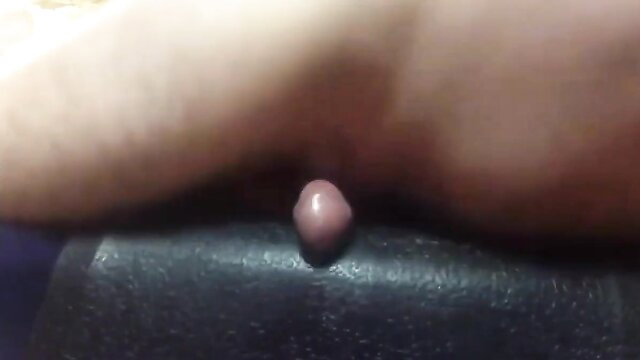 Closeup of woman's pink clit humping black rubber mat