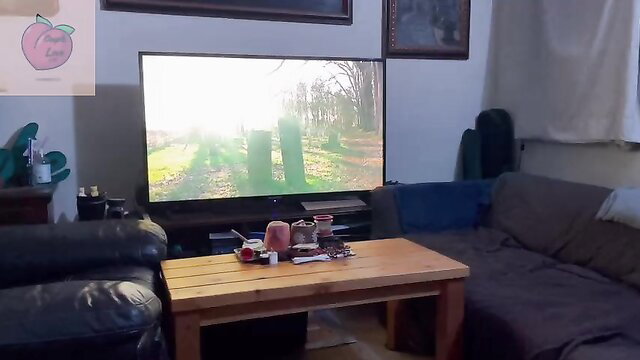 CoupleLove91783 cozy living room movie night with TV on, snacks on table