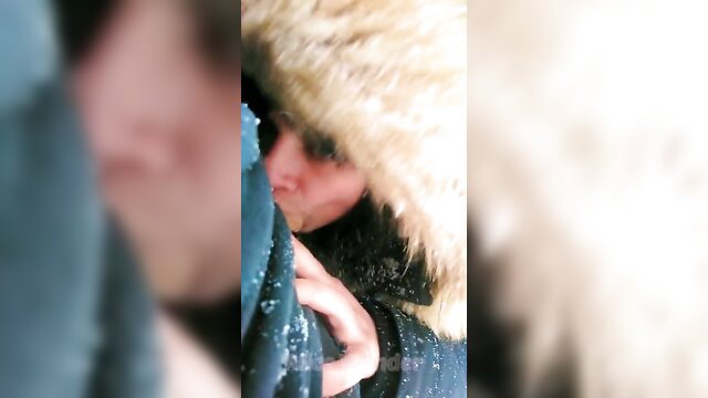 Snowy outdoor public blowjob closeup with fur hood in freezing trails