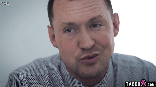 Closeup of smirking man in shirt from taboo employee fucks boss's trans wife video