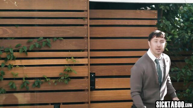 Cubbi Thompson with suited neighbor at wooden gate