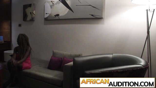 African amateur hottie in pink dress sits on couch ready for steamy sex