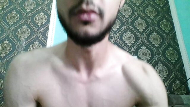 Muscular Arab man with beard shirtless closeup