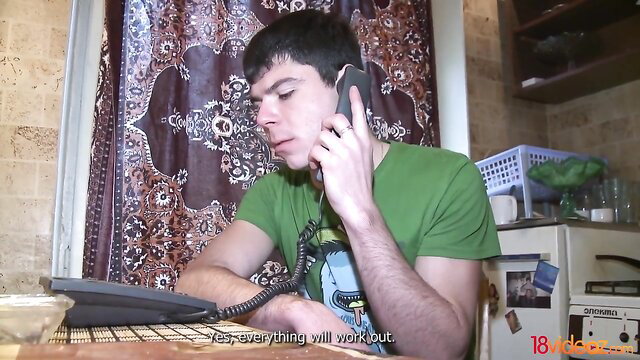 Young Middle Eastern man on phone call in green shirt, amateur home video
