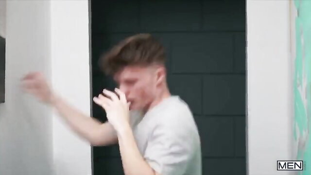 Young white twink in white tee shadowboxes intensely in gym