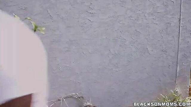 Black busty MILF facials cumshot closeup on gray wall