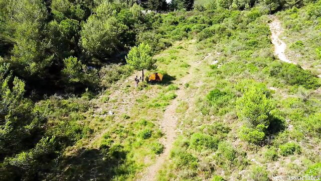 Drone view of young couple camping and fucking outdoors in woods