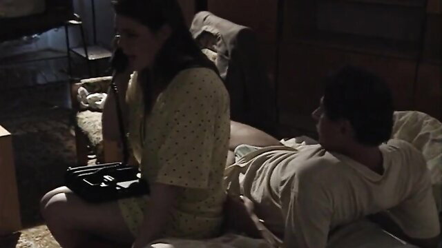 Anna Gyorgyi in polka dot dress straddling man in Kis Romulusz 1995