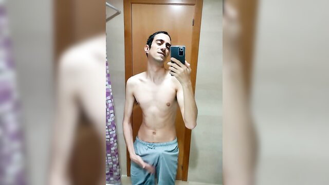 Skinny guy in bathroom mirror selfie, bulging shorts, ballbusting tease