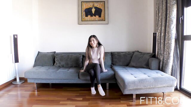 Anya Krey Arab teen in tank top and leggings on couch