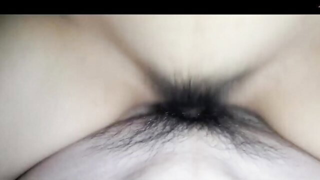 Closeup amateur Asian pussy with dark pubic hair spread wide open