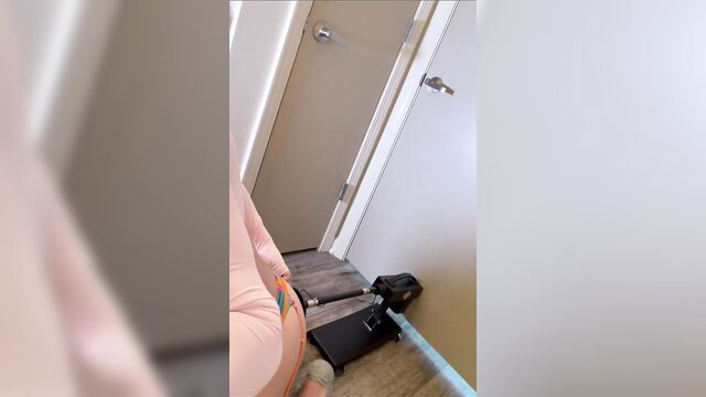 Hot girl in pink panties braces against door as sex machine drills her big ass