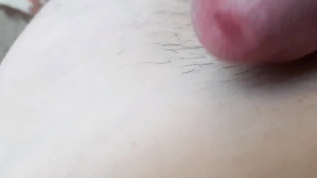 Close-up of Russian boy's circumcised cock head ejaculating on hairy white skin