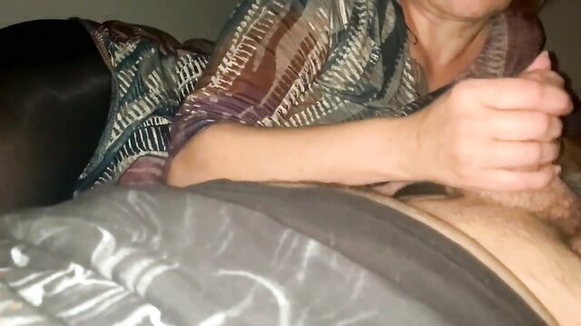 Mature white woman giving handjob to black man in bed HD clip