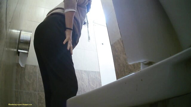 Amateur voyeur cam of woman bending over in gas station toilet