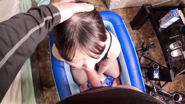 POV closeup of obedient Asian call girl sucking cock in inflatable pool