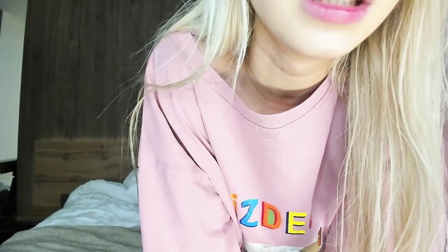Blonde babe in pink sweatshirt teases lips closeup, Chaturbate amateur solo