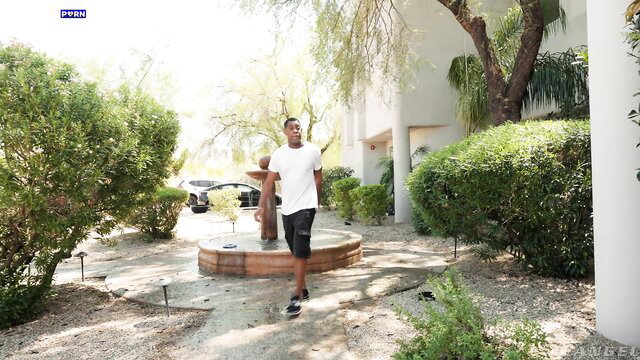 Rebel Rhyder walking outdoors in tight white tee and shorts