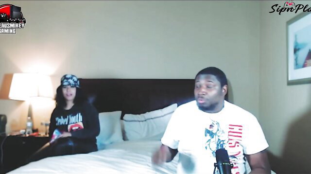 Black guy and Asian girl chilling on bed in amateur home porn scene