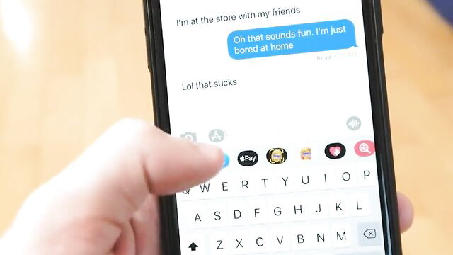 Bored busty redhead stepsis texts on phone in store, hand on iPhone keyboard