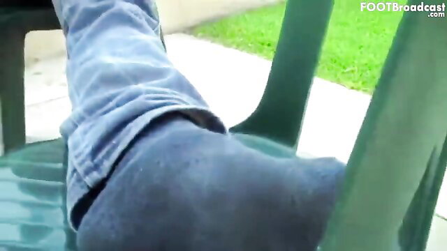 Cody chilling in tight jeans, barefoot soles up on chair in Xander foot fetish vid