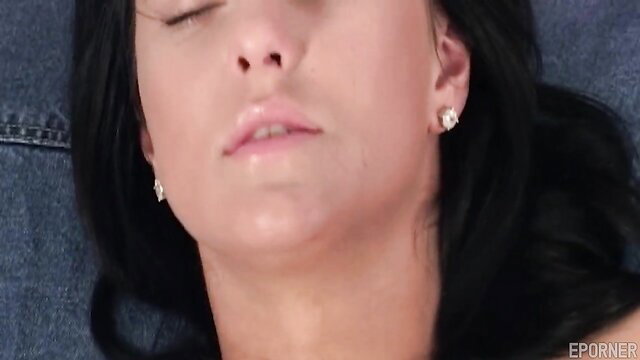 Closeup of sultry brunette's glossy lips and serene face in steamy solo tease