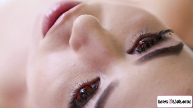 Busty alien body snatcher closeup with seductive red eyes and glossy lips