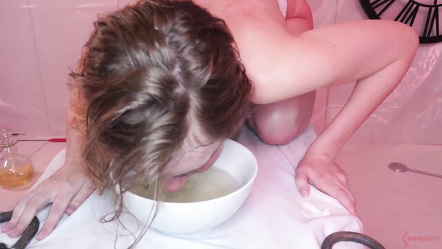 Rebel Rhyder nude on knees, face in bowl in BDSM play