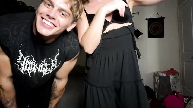 Alphavibesxxx twink smiles with busty woman in black lingerie dress