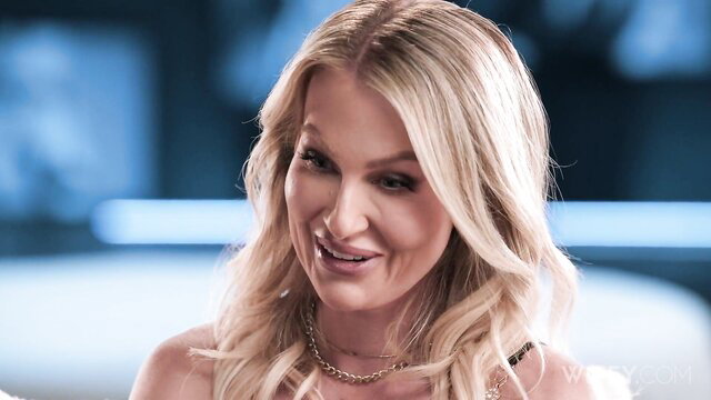 Blonde bombshell Andi Avalon smirks seductively close-up