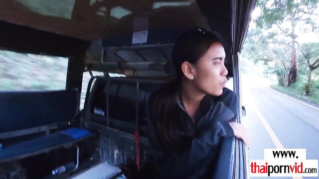 Sexy amateur Thai teen in bus leaning out window, dark hair
