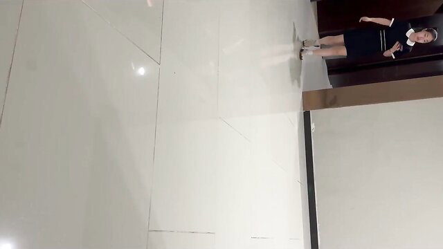 Asian girl in schoolgirl uniform squatting to piss in toilet