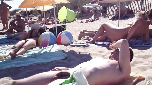 Cap d'Agde nude beach voyeur POV with naked bodies sunbathing