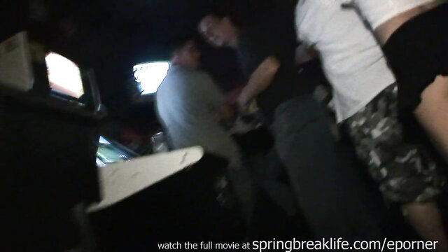 Blurry amateur group of Asian men in arcade playing games