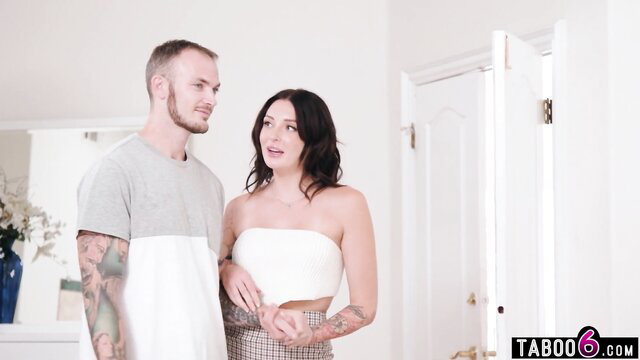 Tattooed white couple in skimpy outfits talking intimately